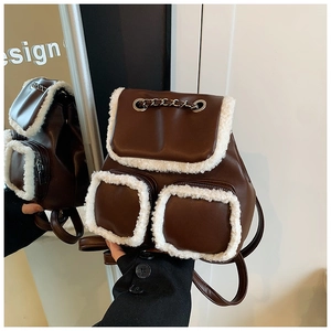 Brown faux leather backpack with plush white sheepskin trim and stylish chain detail