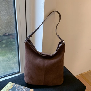 Detailed view of the dark brown matte suede hobo bag with a zipper and leather strap