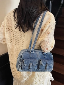 Retro washed denim underarm bag with double pockets on beige knit outfit background