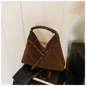 Detail of dark brown suede tote bag with geometric design and smooth leather straps
