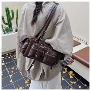Detail view of coffee PU leather baguette bag with multi-pockets and adjustable strap
