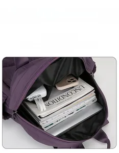 Detailed interior of purple backpack with multiple pockets and laptop compartment