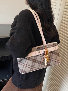 Retro plaid shoulder bag with pink leather strap and decorative beaded charm