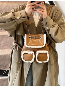 Vintage brown leather backpack with plush fur trim and chain straps for autumn fashion