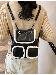 Retro black leather backpack with white faux fur trim and silver chain straps for women