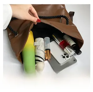 Top view of large brown leather tote bag interior showing ample storage for daily essentials