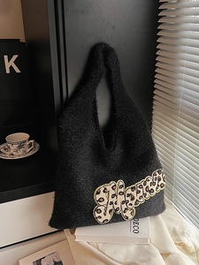 Black fuzzy hobo bag with leopard print Mama patch and plush knit texture for autumn