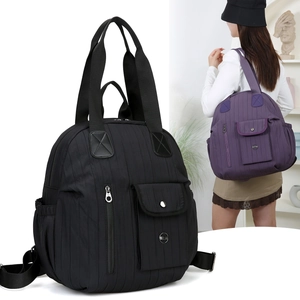 Detail view of water-resistant nylon travel backpack with vertical quilted texture
