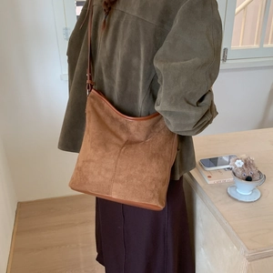 Brown frosted leather tote bag detail with vintage trim and long shoulder strap