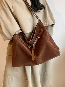 Large dark brown suede tote bag for women showing a minimalist shoulder carry style
