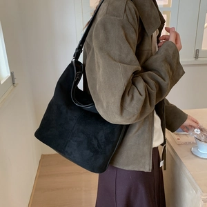 Close-up of black matte suede shoulder bag showing large capacity and hobo bag texture