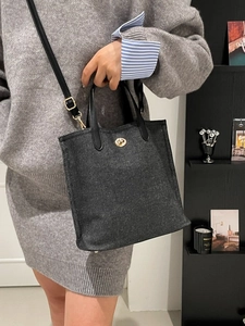 Dark gray denim bucket bag with gold clasp and leather handles for women's daily commute