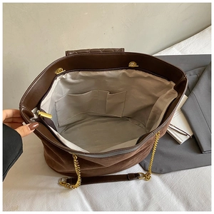 Detailed interior of vintage brown tote bag with smooth lining and multiple compartments