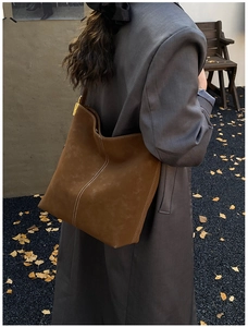 Brown oversized hobo bag in frosted leather with decorative white stitching detail