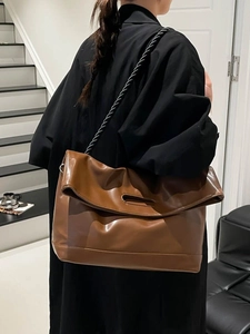 Brown large capacity faux leather tote bag with unique top handle and black rope strap