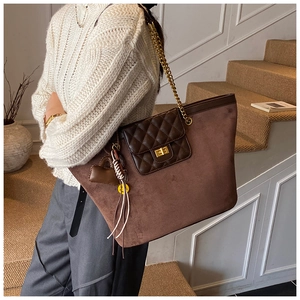 Brown frosted tote bag with gold chain strap and quilted flap shown on a model