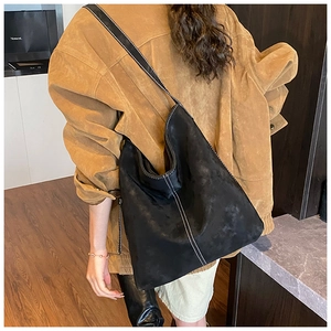 Detail of black large Hobo bucket bag with white contrast stitching and soft texture