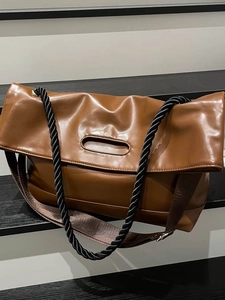 Brown leather large tote bag with unique woven rope strap and minimalist cut-out handle