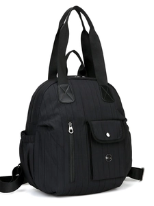 Quilted black travel backpack with dual handles and multiple functional pockets