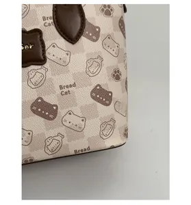 Detailed close-up of cat print material with cross-grain texture on a beige tote bag