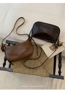 Close-up of retro crescent bags in brown and coffee colors with decorative wooden beads