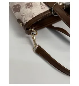 Detail of high-quality golden hardware clasp and detachable brown strap on the cat bag