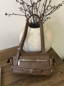 Brown vintage faux leather pillow bag with silver buckle details for women