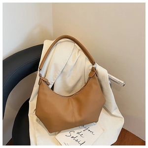 Vue détaillée du sac demi-lune caramel avec surpiqûres sur tissu en velours côtelé