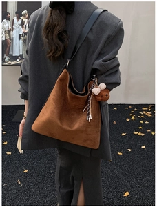 Brown suede shoulder bag with plaid bow teddy bear charm and sleek black straps