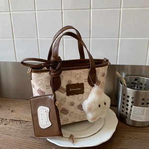 Detail of the Bread Cat tote bag set featuring printed PU leather and plush pendant accessory
