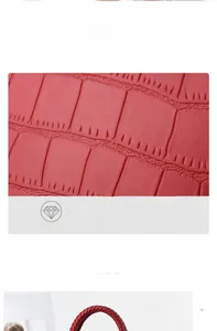 Close-up of textured red PU leather bag showing crocodile pattern and woven handle