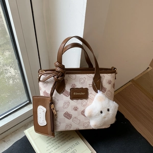 Detail of cartoon cat print tote bag with mini pouch and star plush keychain