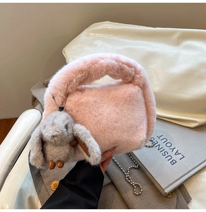 Close-up of pink faux rabbit fur bag featuring a cute bunny pendant and silver chain strap