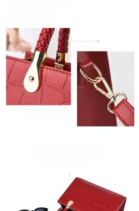 Detail of red croc-embossed leather bag showing gold hardware and magnetic closure