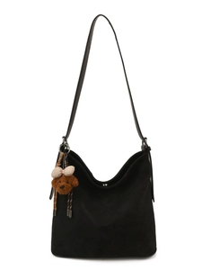 Classic black suede hobo tote bag with a cute plush bear charm for daily commuting