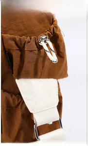Detail view of caramel brown travel bag featuring braided drawstring and reinforced stitching