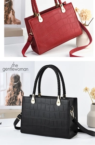 Close-up of crocodile-textured faux leather handbag with elegant woven handles and gold hardware