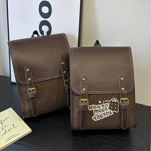 Detailed comparison of brown leather backpack in two sizes with white stitching details