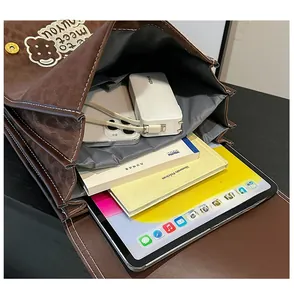 Internal storage detail showing a brown leather bag holding an iPad and books