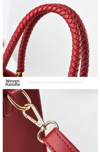 Detail of red leather woven handle with premium polished gold metal buckles and zipper