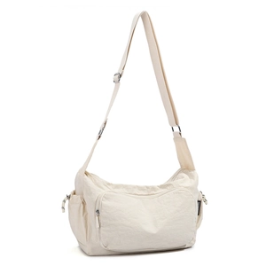 Detail of nylon messenger bag showing adjustable strap and silver metal buckle