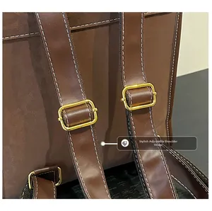 Detail of adjustable brown leather backpack strap with high-quality golden metal buckle