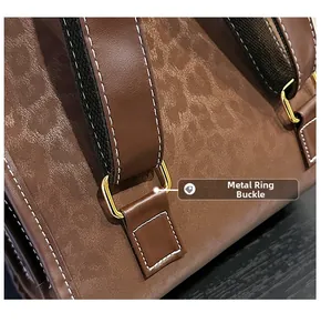 Close-up of golden metal buckle and leopard pattern leather on stylish brown backpack