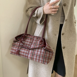 Detail showing red and blue plaid wool tote bag with burgundy PU leather shoulder strap