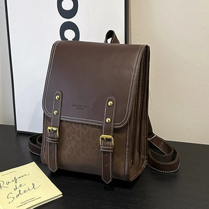 Detail of retro leather backpack with leopard print texture and gold buckles