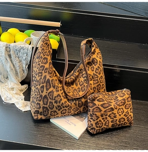 Detail of leopard print tote bag with brown faux leather strap and matching pouch set
