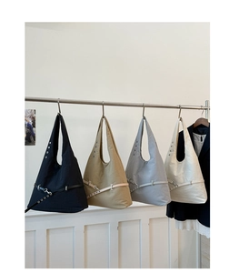 Detail of four color options for the large capacity tote bag with metal buckle accents