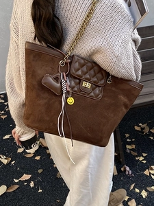 Vintage brown frosted leather tote bag with gold chain strap and decorative charms