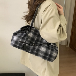 Black and white plaid wool tote bag showing large capacity and soft shoulder straps