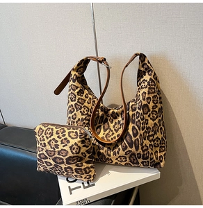Close-up of leopard print tote bag with matching makeup pouch and adjustable straps